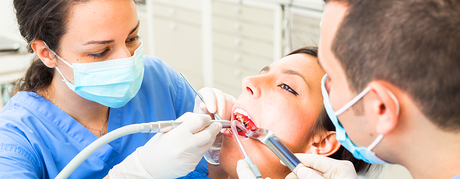 Dental assistant assisting the dentist during a variety of treatment procedures