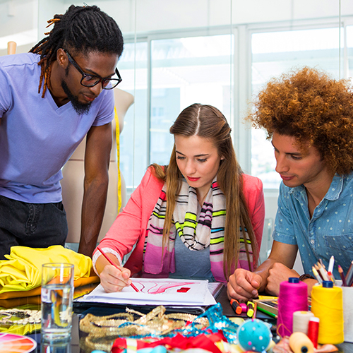 Fashion designers creating and visualising an idea and producing a design by hand