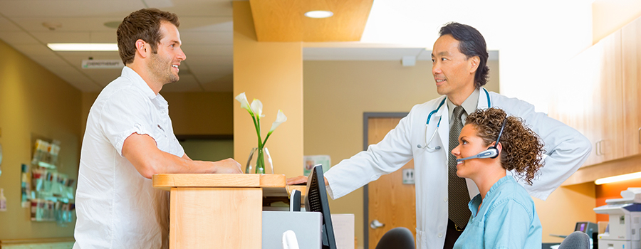 Medical Assistant and doctor making arrangements with the patient to schedule an appointment