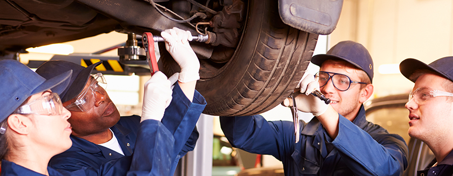 Instructor training students to maintain and repair a Honda vehicle