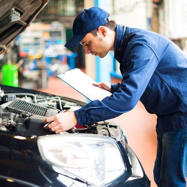 Automotive technician doing a diagnosing problems in a car