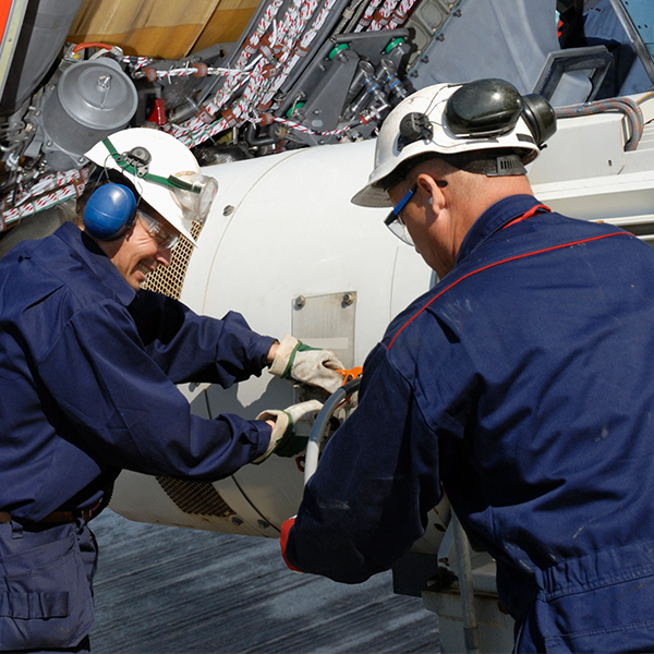 Mechanics inspecting and repairing airplane to ensure they’re operating correctly and safely