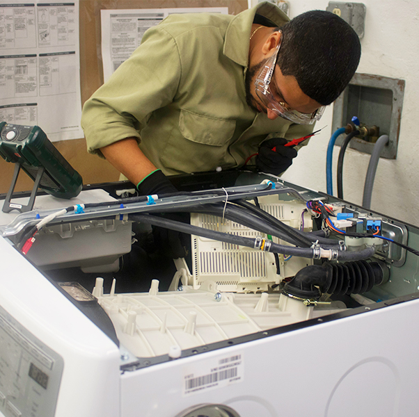 Appliance repair technician repairing any defective component on the washer