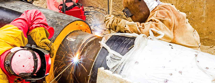 Welders fabricating and assembling metal structures in construction site