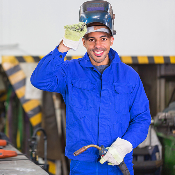 Welder setting up and maintaining welding equipment