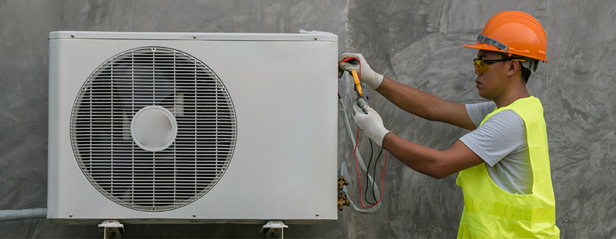 Technician is checking air conditioner 