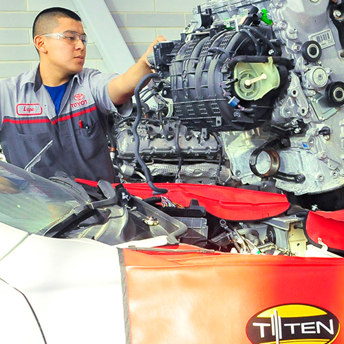 Toyota student performing an engine swap on a Toyota vehicle