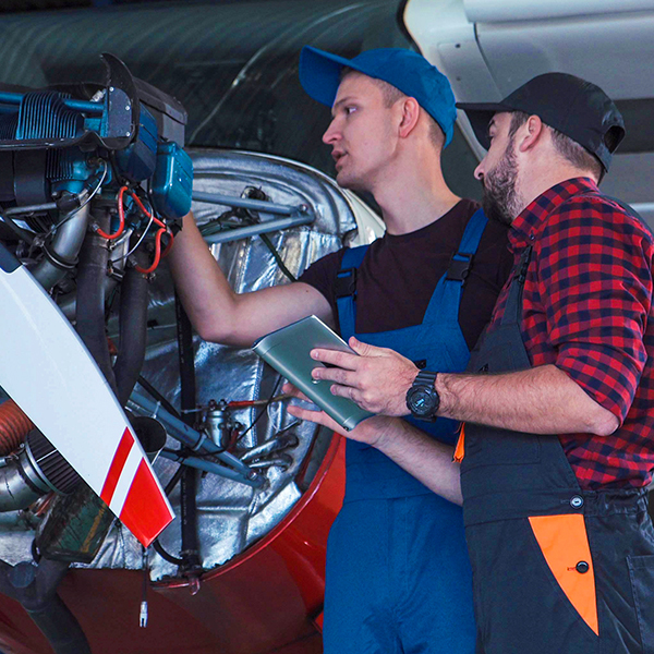 Technicians adjusting avionics equipment